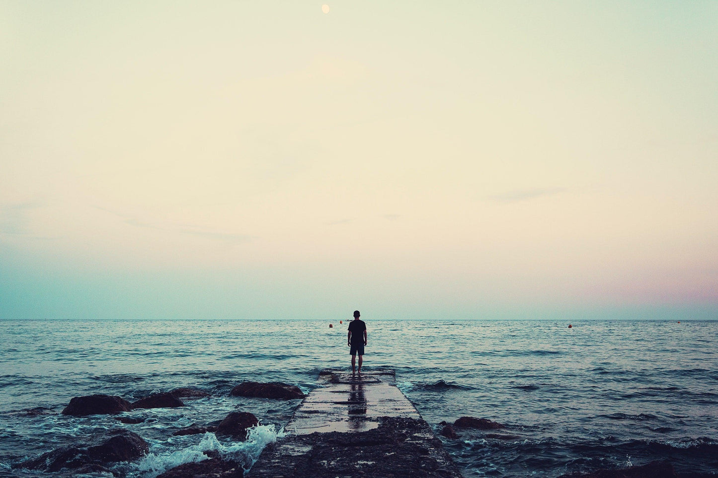 Caption: Visual aids can help recharge your mind. Man on pier in sea